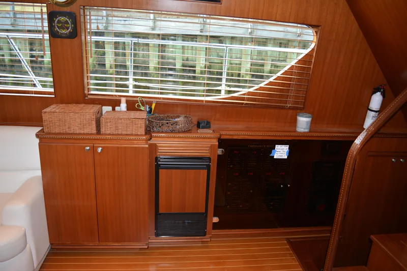 Wandra Yacht Photos Pics Interior of 2008 Novatec Islander 60 yacht with wooden cabinetry and window blinds.