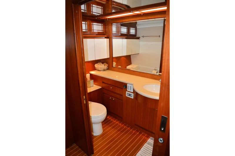 Wandra Yacht Photos Pics Luxurious bathroom in 2008 Novatec Islander 60 yacht with wood accents and modern fixtures.