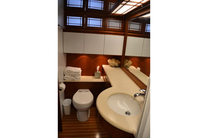 Wandra Yacht Photos Pics Luxurious bathroom in 2008 Novatec Islander 60 yacht with elegant wood accents and modern fixtures.