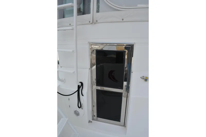 Wandra Yacht Photos Pics White exterior of 2008 Novatec Islander 60 yacht with ladder and window.