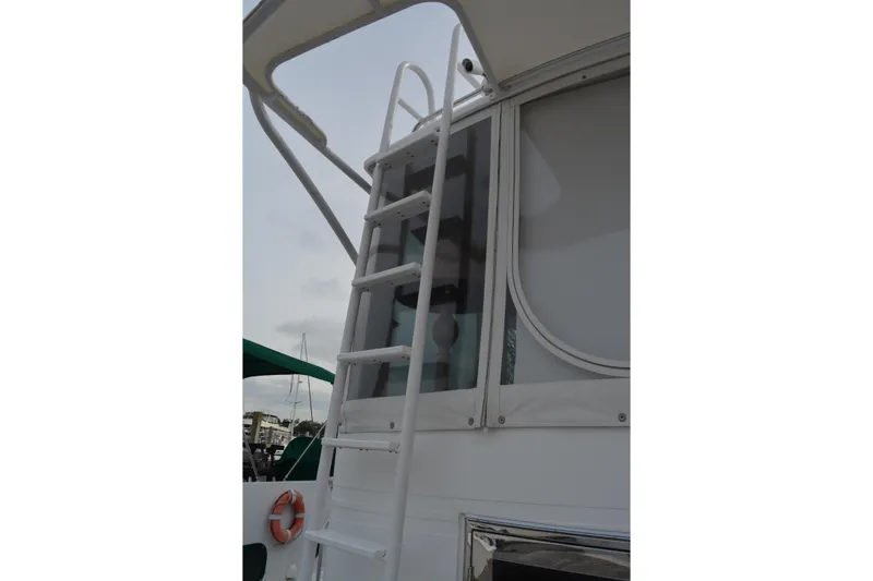 Wandra Yacht Photos Pics Ladder on 2008 Novatec Islander 60 yacht, exterior view with canopy and life preserver.