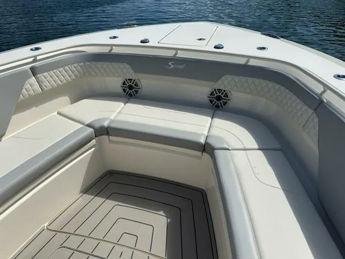  Yacht Photos Pics 2023 Scout 377 LXF boat interior with cushioned seating and speakers, on calm water.