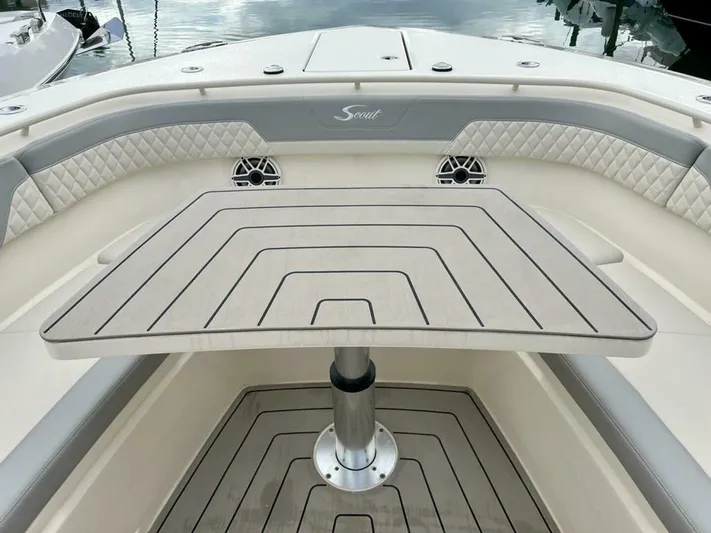  Yacht Photos Pics 2023 Scout 377 LXF boat interior with elegant seating and table setup.