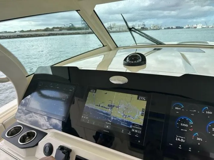  Yacht Photos Pics 2023 Scout 377 LXF boat dashboard with navigation and control screens on open water.