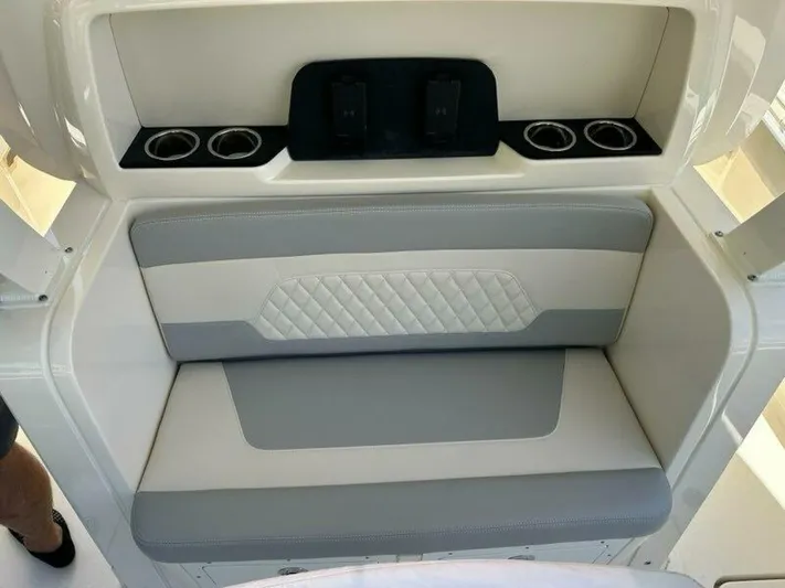  Yacht Photos Pics 2023 Scout 377 LXF boat seating area with cup holders and modern design.