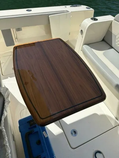  Yacht Photos Pics 2023 Scout 377 LXF boat interior with wooden table and seating area.