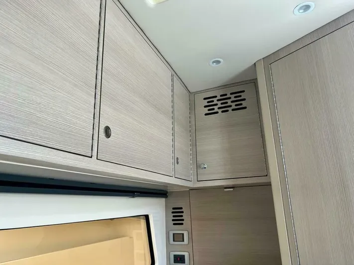  Yacht Photos Pics 2023 Scout 377 LXF interior cabinetry with modern wood finish and built-in lighting.
