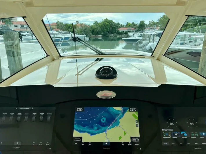  Yacht Photos Pics 2023 Scout 377 LXF boat dashboard with navigation screens and marina view.