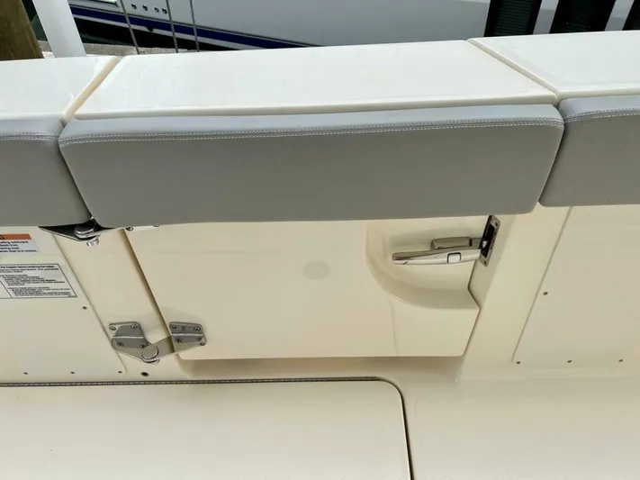  Yacht Photos Pics 2023 Scout 377 LXF boat interior with cushioned seating and storage compartment.