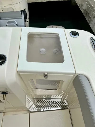  Yacht Photos Pics 2023 Scout 377 LXF boat interior with storage compartment and seating area.