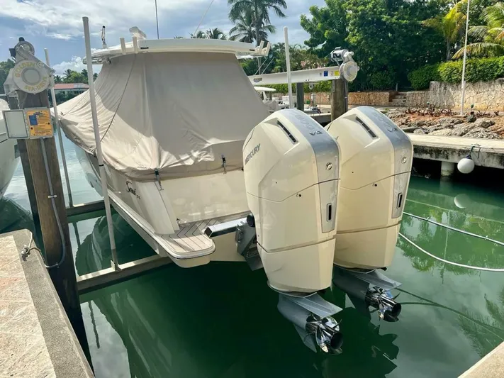  Yacht Photos Pics 2023 Scout 377 LXF boat with dual outboard engines docked in a marina.