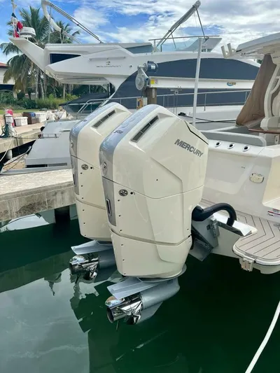  Yacht Photos Pics 2023 Scout 377 LXF boat with dual Mercury outboard engines docked in a marina.