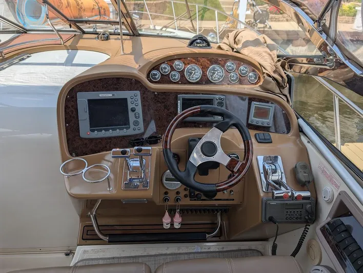 No Drama Yacht Photos Pics 2002 Regal Commodore 3860 boat dashboard with steering wheel and navigation instruments.
