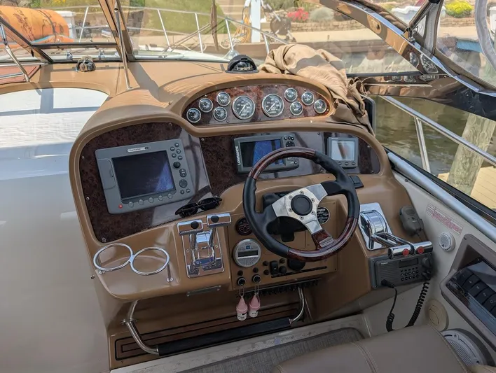 No Drama Yacht Photos Pics 2002 Regal Commodore 3860 boat dashboard with steering wheel and navigation controls.