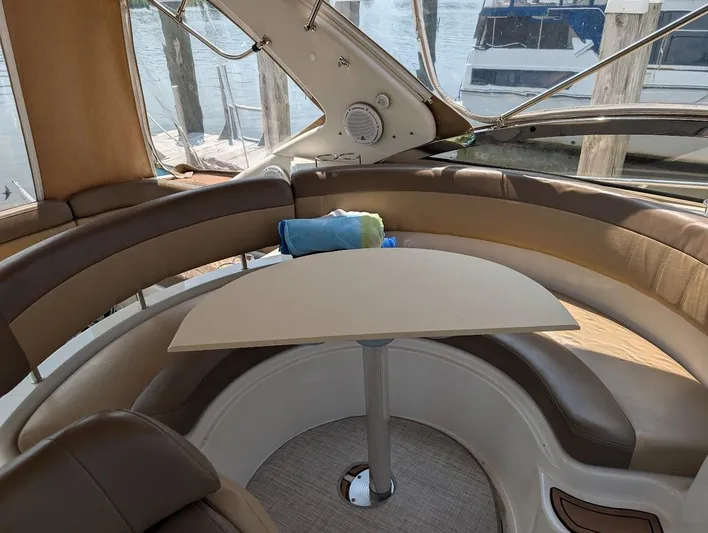 No Drama Yacht Photos Pics Interior of 2002 Regal Commodore 3860 yacht with curved seating and table.