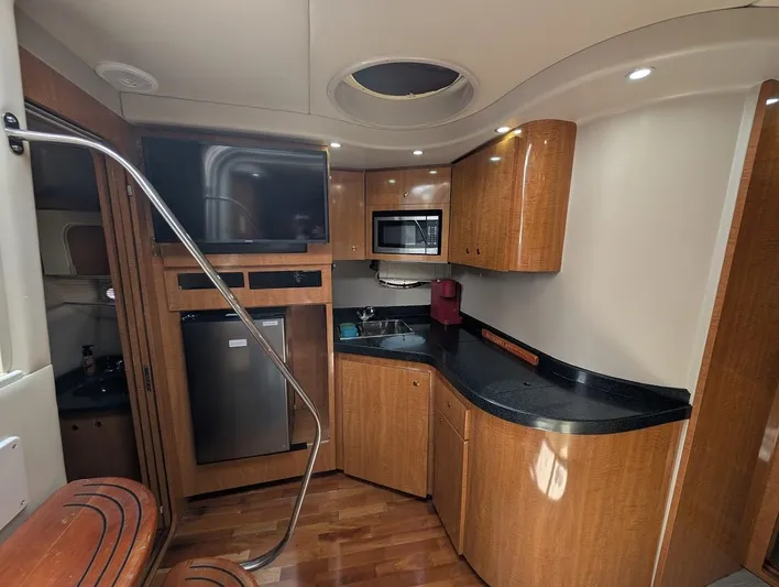 No Drama Yacht Photos Pics 2002 Regal Commodore 3860 yacht interior with kitchenette, wood cabinetry, and modern appliances.