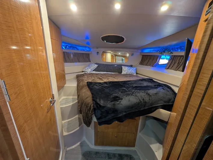 No Drama Yacht Photos Pics Luxurious cabin interior of 2002 Regal Commodore 3860 yacht with cozy bedding and ambient lighting.