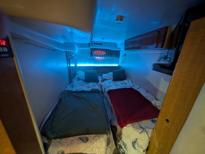No Drama Yacht Photos Pics Interior cabin of 2002 Regal Commodore 3860 with cozy twin beds and ambient lighting.