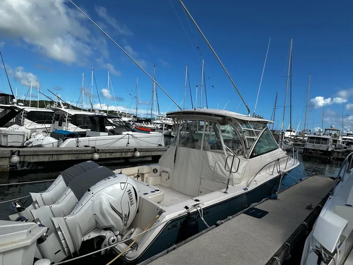  Yacht Photos Pics 2021 Grady-White Express 370 boat docked at marina under clear blue sky.