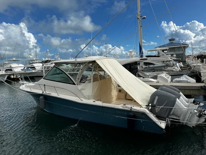  Yacht Photos Pics 2021 Grady-White Express 370 boat docked at marina under cloudy sky.
