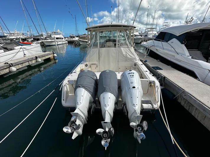  Yacht Photos Pics 2021 Grady-White Express 370 boat docked with triple outboard engines.