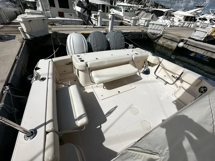  Yacht Photos Pics 2021 Grady-White Express 370 boat docked, featuring spacious seating and dual outboard motors.
