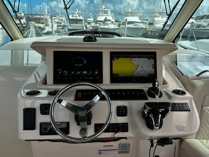  Yacht Photos Pics 2021 Grady-White Express 370 helm with navigation screens and steering wheel.