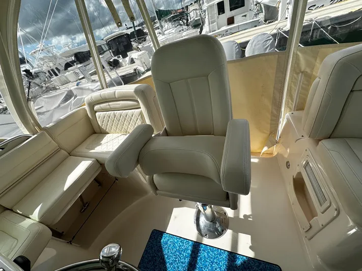  Yacht Photos Pics 2021 Grady-White Express 370 boat interior with plush seating and helm chair.