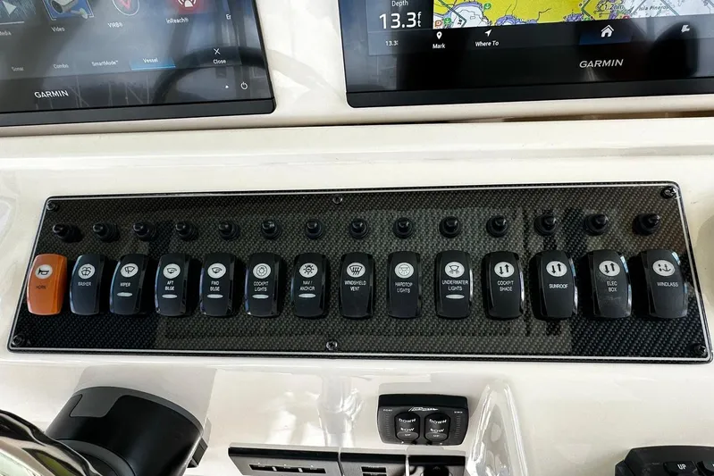  Yacht Photos Pics Control panel of 2021 Grady-White Express 370 boat with labeled switches and Garmin displays.