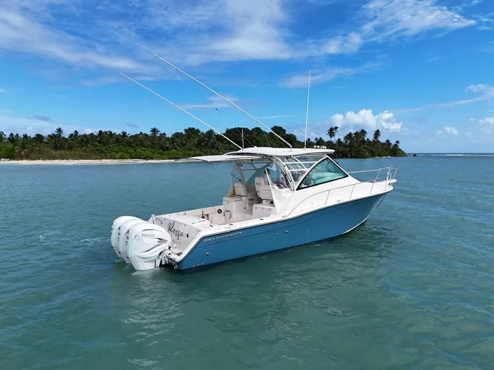  Yacht Photos Pics 2021 Grady-White Express 370 boat on clear blue water near tropical island.