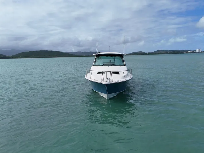  Yacht Photos Pics 2021 Grady-White Express 370 boat on calm water with scenic background.