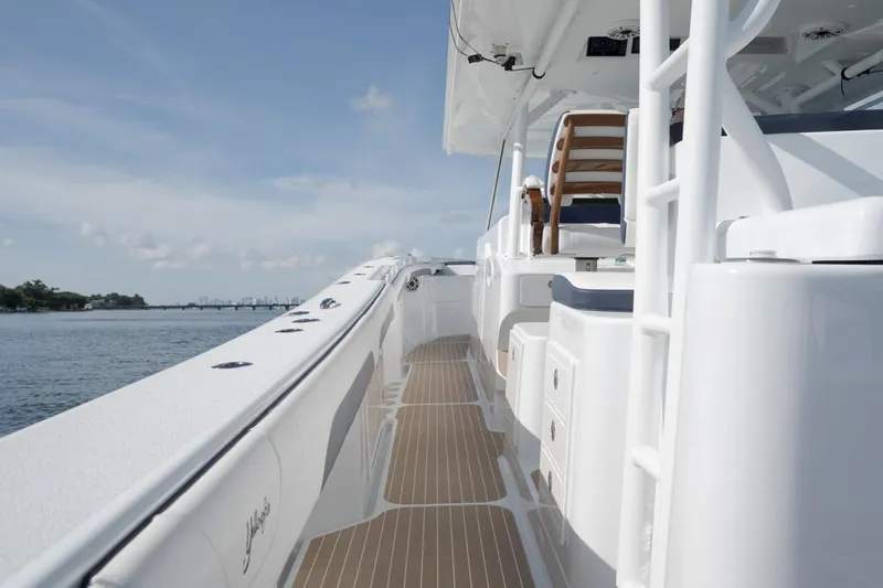  Yacht Photos Pics 2022 Yellowfin 54 Offshore boat deck with seating, cruising on calm waters.