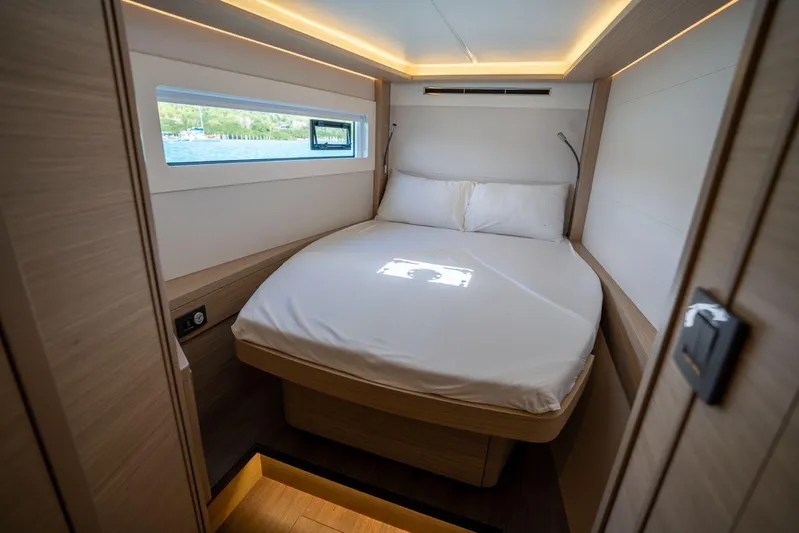 Blossom Yacht Photos Pics Luxurious cabin interior of 2024 Lagoon 46 yacht with cozy bed and modern lighting.