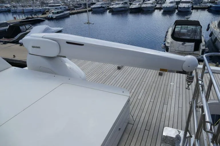  Yacht Photos Pics 2016 Princess 72 Flybridge Motor Yacht with crane on deck, docked at marina.