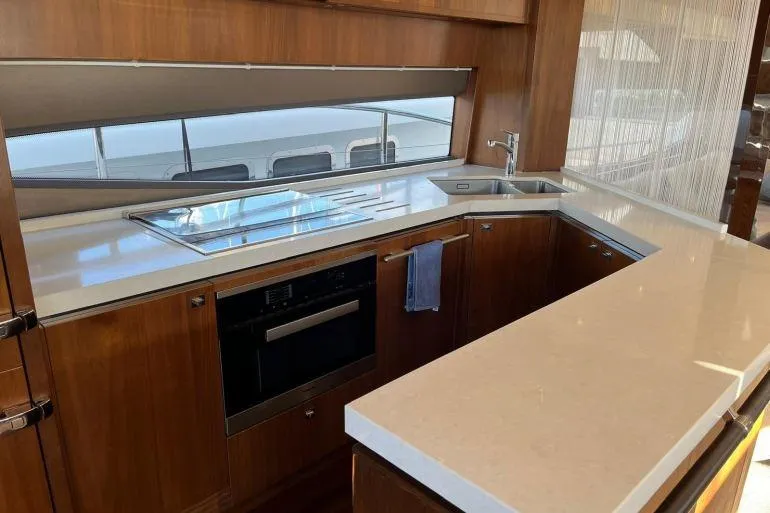  Yacht Photos Pics Luxurious kitchen interior of 2016 Princess 72 Flybridge Motor Yacht with modern appliances.