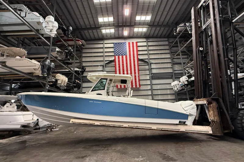  Yacht Photos Pics 2017 Boston Whaler 350 Outrage in warehouse with American flag backdrop.