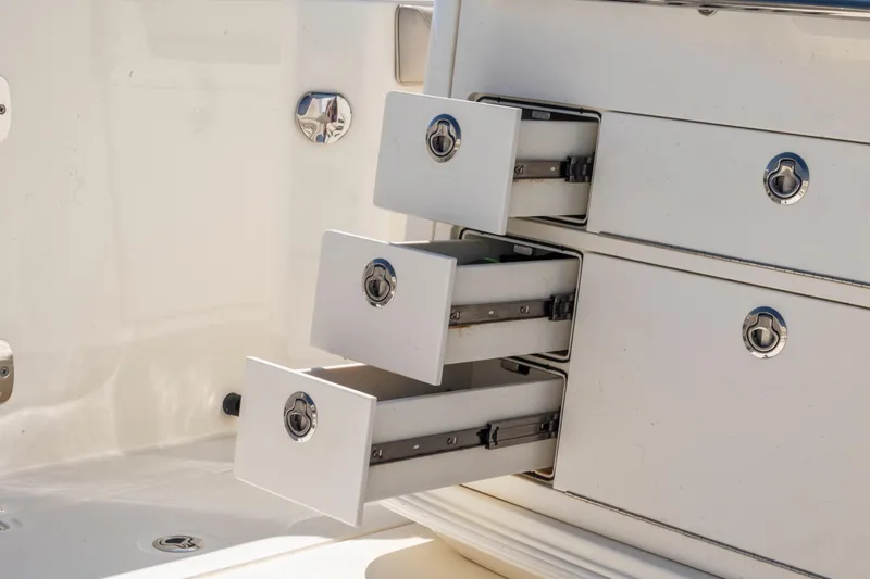  Yacht Photos Pics 2017 Boston Whaler 350 Outrage boat storage drawers open, showcasing sleek design.