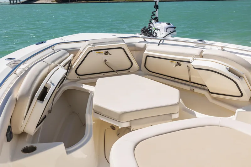  Yacht Photos Pics 2017 Boston Whaler 350 Outrage boat interior with cushioned seating and storage compartments.