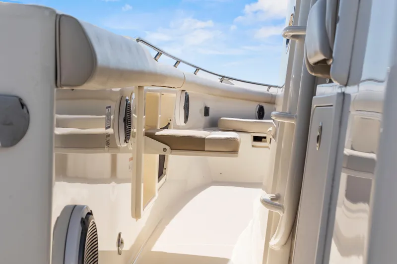  Yacht Photos Pics 2017 Boston Whaler 350 Outrage interior with seating and storage, under a clear blue sky.