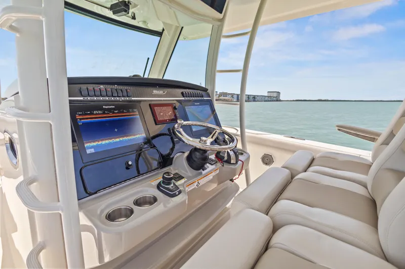  Yacht Photos Pics 2017 Boston Whaler 350 Outrage helm with advanced navigation displays and comfortable seating.