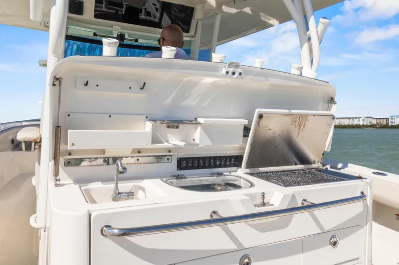  Yacht Photos Pics 2017 Boston Whaler 350 Outrage boat with open galley, sink, and grill on deck.