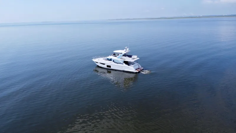  Yacht Photos Pics 2022 Azimut Fly 60 yacht cruising on calm blue waters.