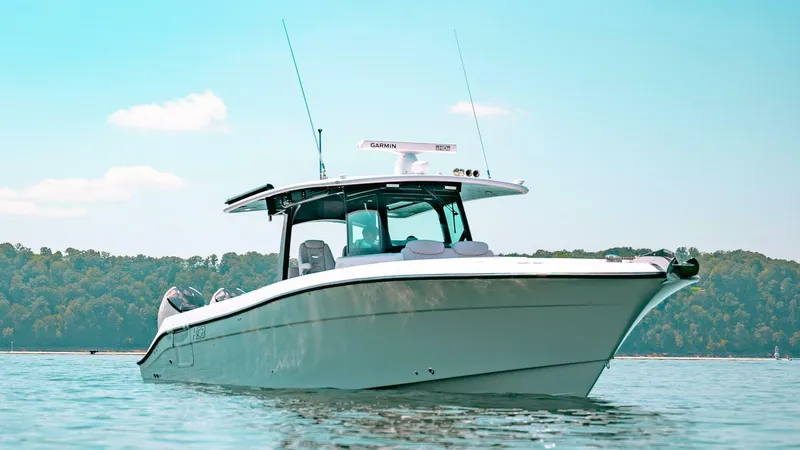  Yacht Photos Pics 2024 HCB 42 Lujo boat on calm water with forested background.