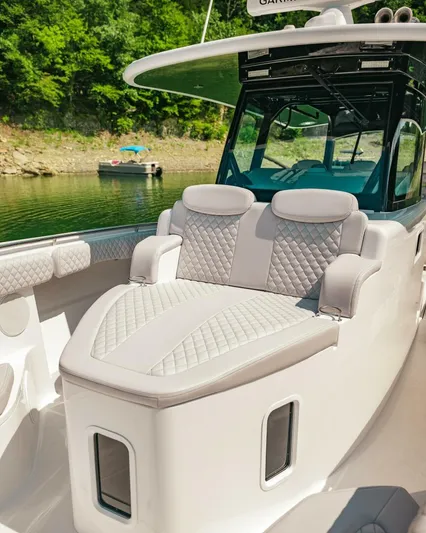  Yacht Photos Pics 2024 HCB 42 Lujo luxury boat with plush seating on a serene lake.