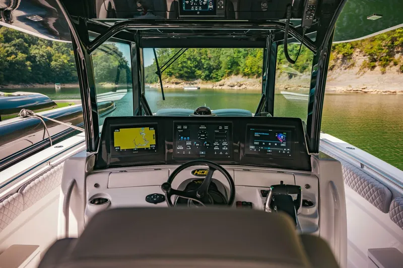  Yacht Photos Pics 2024 HCB 42 Lujo boat cockpit with advanced navigation systems and scenic lake view.