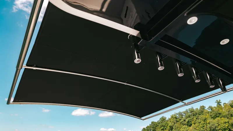  Yacht Photos Pics 2024 HCB 42 Lujo boat canopy against blue sky and trees.