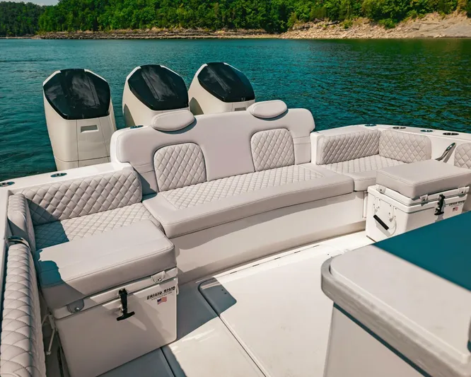  Yacht Photos Pics 2024 HCB 42 Lujo luxury boat interior with plush seating and powerful engines on a serene lake.