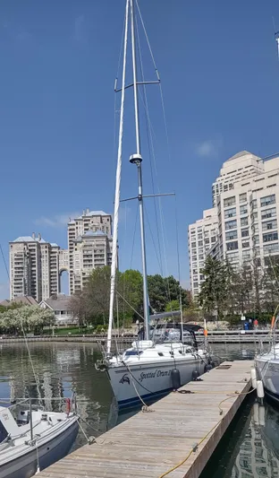 Spotted Drum II Yacht Photos Pics 2004 Catalina 42 Mk II sailboat docked in urban marina with skyscrapers in background.