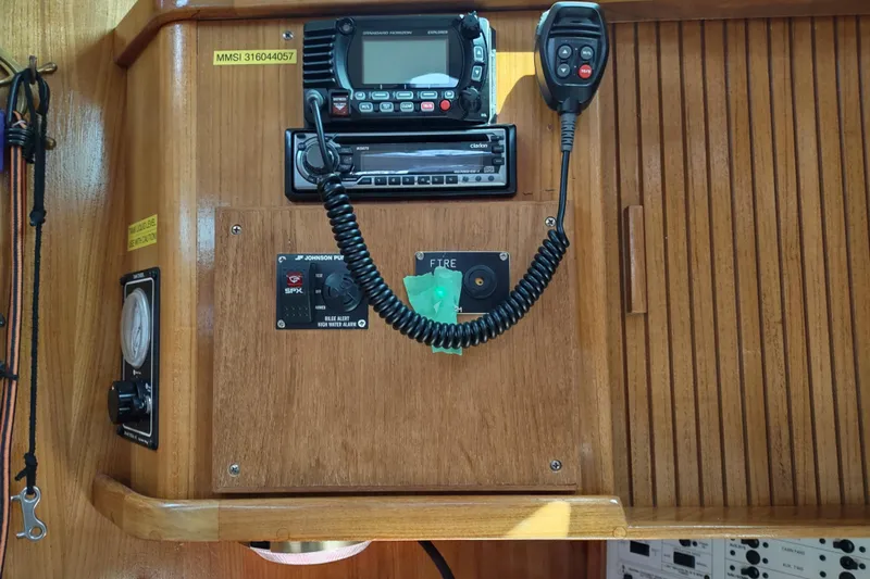 Spotted Drum II Yacht Photos Pics Control panel of a 2004 Catalina 42 Mk II sailboat with radio and navigation equipment.