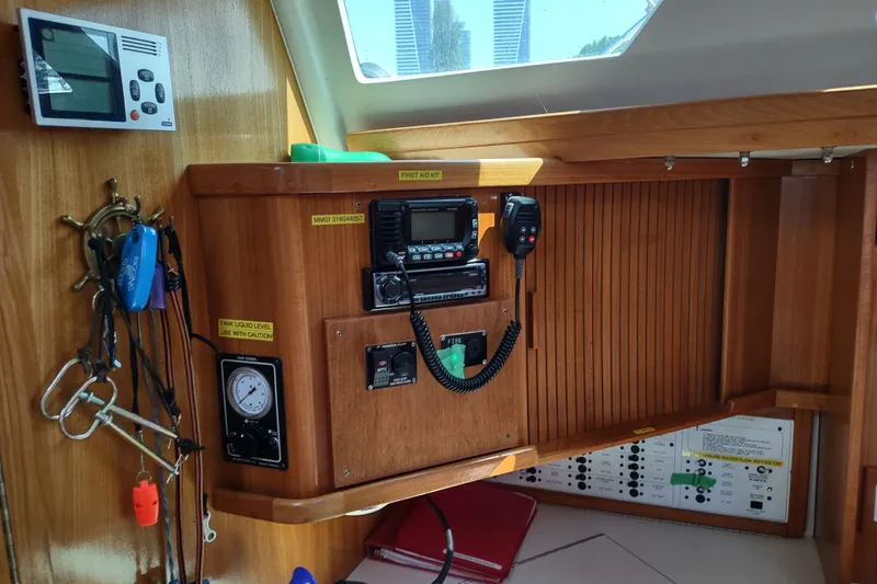 Spotted Drum II Yacht Photos Pics Navigation station inside a 2004 Catalina 42 Mk II sailboat, featuring communication equipment and controls.